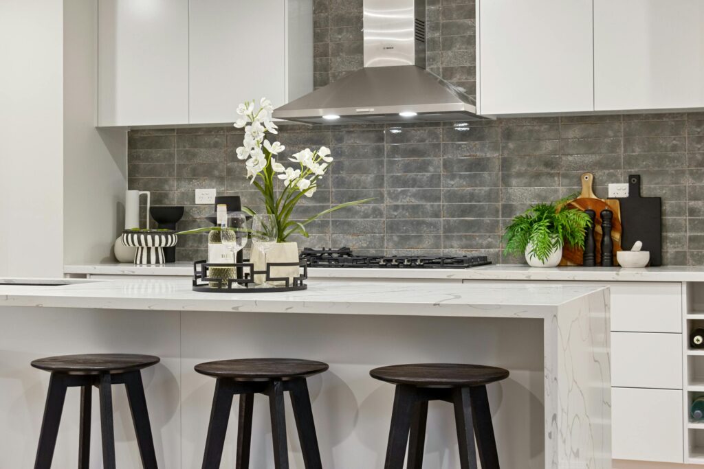 Elegant contemporary kitchen design featuring a marble island and stylish decor.